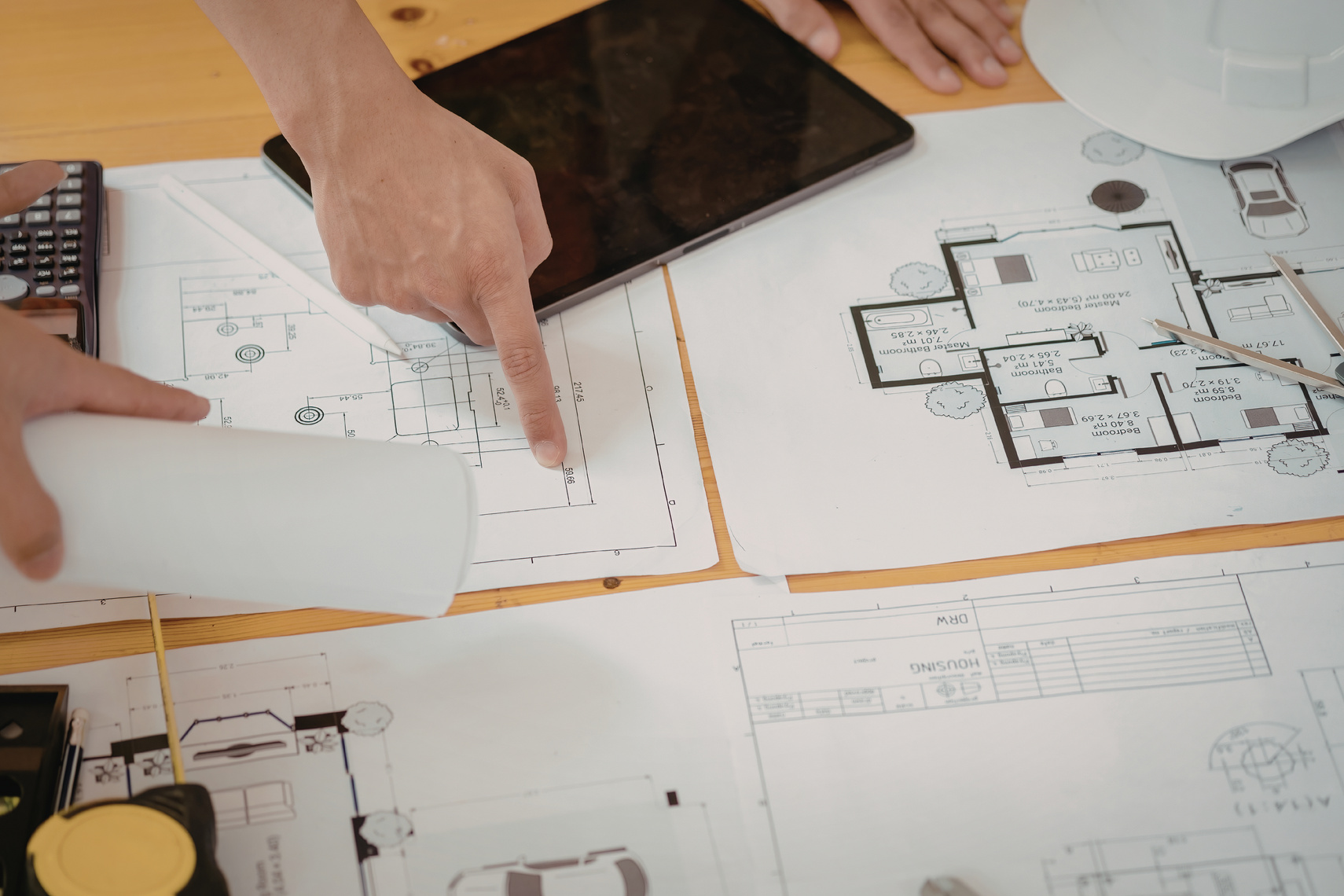Architectural floor plans and drawings on a work table